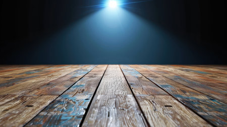 A captivating view of a rustic wooden floor illuminated by a dramatic spotlight, creating a striking contrast against a dark background, ideal for creative projects.の素材