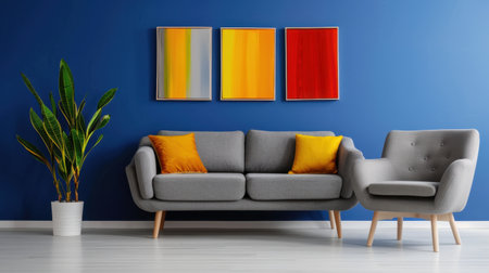 A modern living room setting features a grey sofa with colorful cushions, a stylish armchair, and vibrant artwork against a blue wall, conveying comfort and creativity.の素材