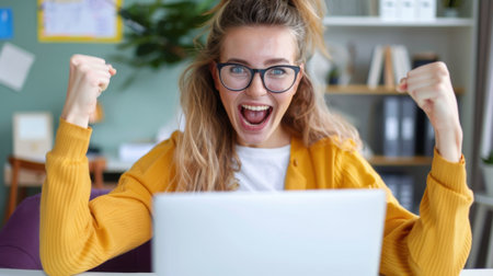 A young woman expresses joy and excitement at her home office after achieving a goal, showcasing a vibrant atmosphere filled with positivity.の素材