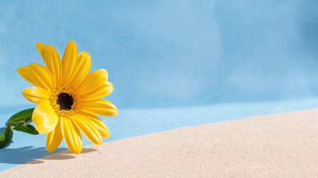 A stunning bright yellow flower gracefully placed against a soft blue background, highlighting natural beauty in a serene and cheerful setting. Perfect for various themes!の素材