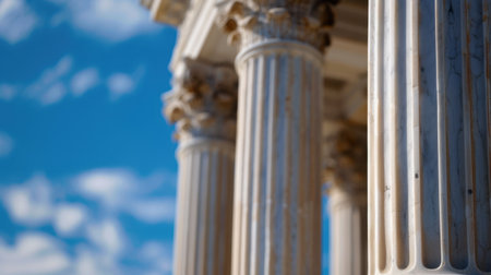 This striking close-up captures the intricate details of ancient marble columns against a vibrant blue sky. Perfect for themes of history and architecture.の素材