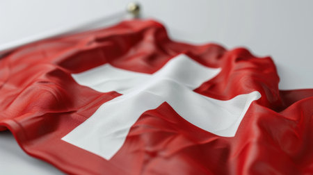 A captivating close-up of a waving Swiss flag, showcasing its vibrant red fabric and iconic white cross. Perfect for themes of patriotism and national identity.の素材