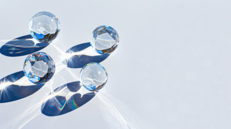 A captivating arrangement of crystal balls reflecting light, casting vivid shadows and creating a stunning visual effect on a smooth surface.の素材
