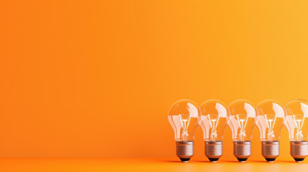 A visually striking image featuring a row of light bulbs set against a vibrant orange background. This composition symbolizes innovation and bright ideas, ideal for creative projects.の素材