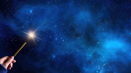 A captivating image featuring a hand holding a magical wand that emits a sparkling light against a mesmerizing blue starry night sky. Perfect for themes of fantasy and imagination.の素材