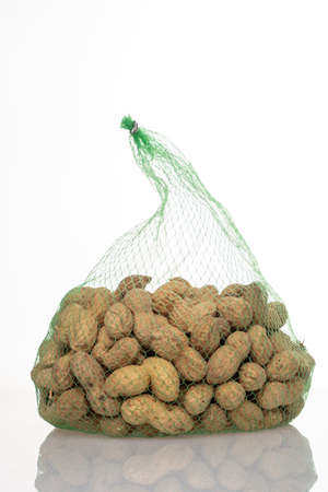 peanuts in a mesh bag on a white background,