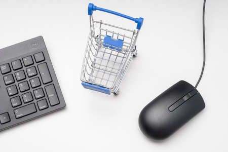 modern smartphone and shopping cart on a colored backgroundの写真素材