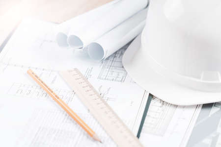 helmet and tools for construction drawings and construction drawings close-up, selective focus