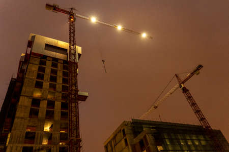 construction work of houses at night, Crane loader At night On the construction site