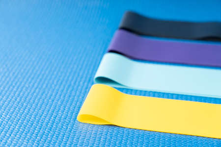 A set of colorful elastic fitness land. Expanders for women