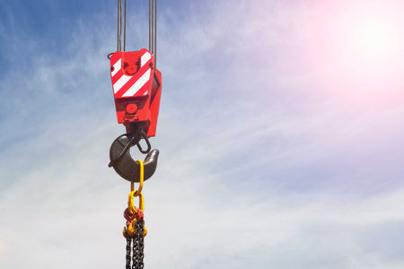 crane hook on blue sky background, construction work conceptの写真素材