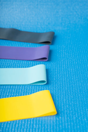 A set of colorful elastic fitness land. Expanders for women