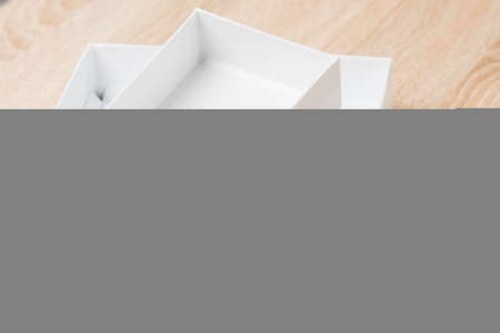 smartphone box, a package of products from a smartphone store. on the table is an empty white box from under the new smartphone, selective focus, tinted imageの写真素材