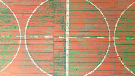 top view of the golden gun. school gym with old wooden covering and multi colored paints of the...