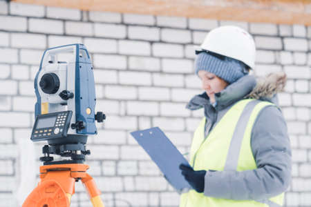 female civil engineer, wearing a white helmet on a construction site close-up, selective focus, tinting, glareの写真素材