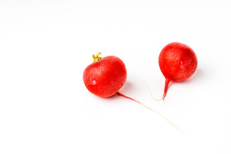 fresh red radish on a white background, the concept of healthy food and non-GMO products, selective focusing, macro photography from different angles, reflection on whiteの写真素材