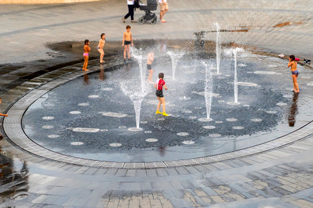 excited boy having fun between water splashes, inのeditorial素材