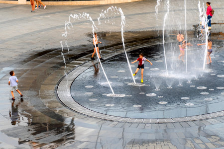 excited boy having fun between water splashes, inのeditorial素材