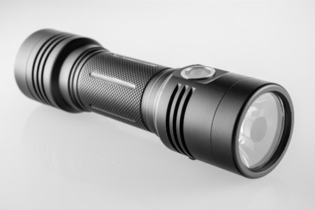 LED black flashlight close-up on white backgroundの写真素材