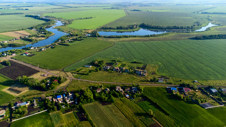 view from a height to the green fields of crops, the pond for irrigation, the sun's glare and tinting,. High quality photoの写真素材