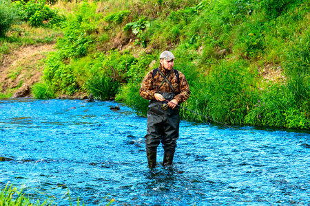 A fisherman catches fish while standing in the water. high quality photoの写真素材