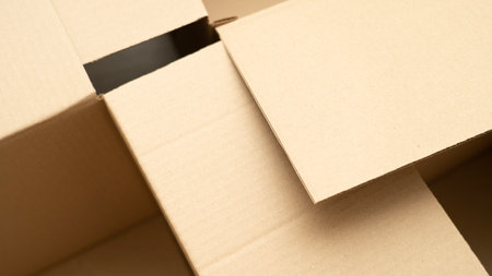 open cardboard boxes close-up, different angles, selective focus, cutout for handle in cardboard boxの写真素材