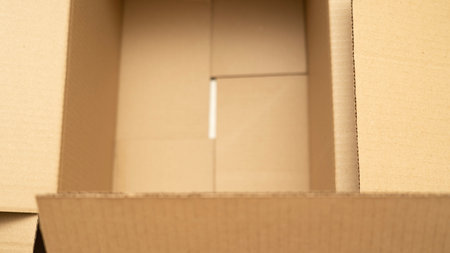 open cardboard boxes close-up, different angles, selective focus, cutout for handle in cardboard boxの写真素材