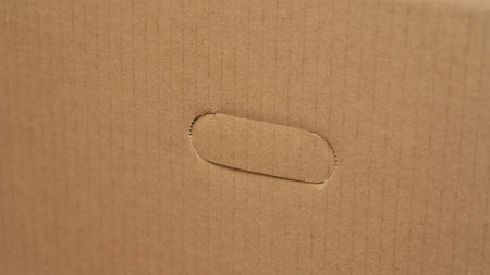 open cardboard boxes close-up, different angles, selective focus, cutout for handle in cardboard boxの写真素材