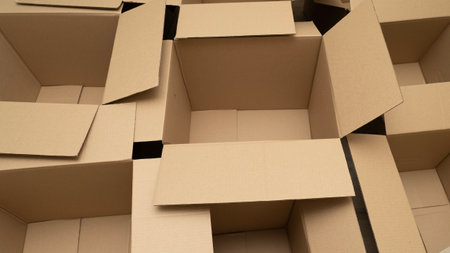 open cardboard boxes close-up, different angles, selective focus, cutout for handle in cardboard boxの写真素材
