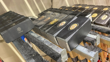 Moscow January 26 2024, A row of hammers are lined up on a shelf. The hammers are all black and have...