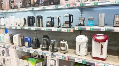 Moscow, February 05 2024. Display case with large number of electric kettles in supermarket Kitchen appliances department.のeditorial素材