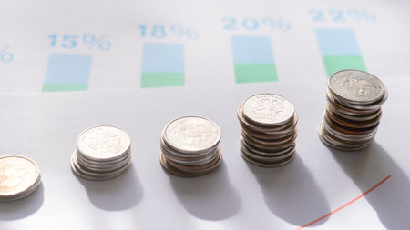 Coins on the background of a graph with percentages, the concept of progressive taxation of...