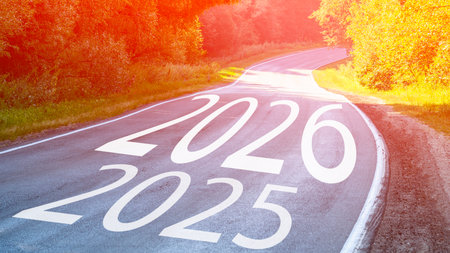 A road with the numbers 2016 and 2025 written on it. The road is surrounded by trees and grass