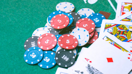 A pair of aces on a green cloth. poker chips on a green cloth for gambling. High quality photo