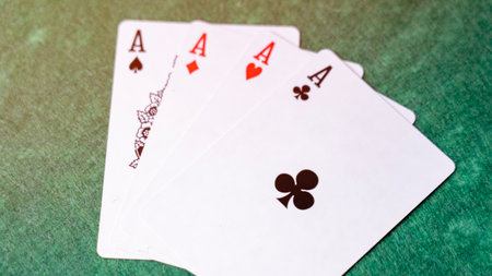 A deck of playing cards with the top card showing the Ace of Spades. The other three cards are the...