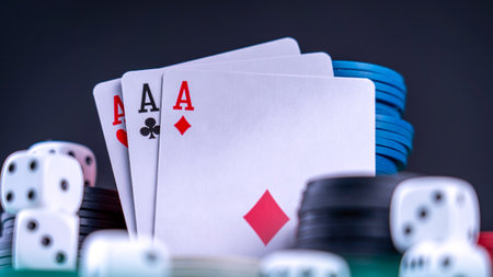 Three high-ranking cards against a backdrop of gaming chips. The essence of casino card games. High quality photoの写真素材