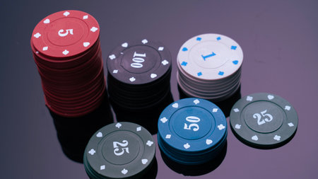A pile of poker chips with numbers on them. The chips are red, white, and blue
