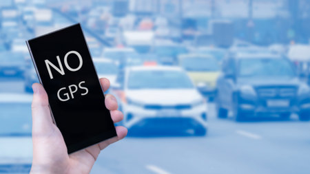 A hand with a smartphone on the background of a busy highway in a megalopolis with the inscription...