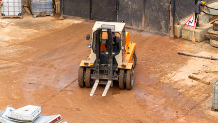 The loader at the construction site. The loader is unloading cargo in a residential area during the sunny summer construction season.の写真素材