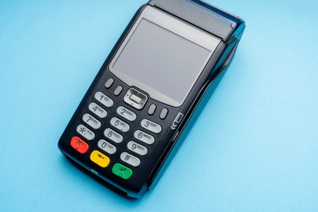 Payment terminal device. A credit card terminal is shown on a white background. A close-up of the...