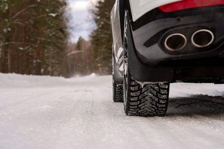A car on a winter studded road on a snowy road. High quality photo