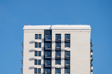 A new building in a new neighborhood against the background of a blue sky. High quality photo