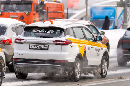 Moscow, December 28, 2025, Taxi car on a snowy street in the city, Fare increase for taxi trains in heavy snowfall. High quality photoのeditorial素材
