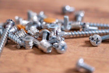 A set of bolts for assembling a new table in close-up. screw the legs to the table, assemble new furniture, the key is inserted into the holes for screwing the bolts on the furniture. High quality photo