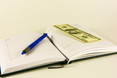 Book for planning and banknote of 100 dollarsの写真素材