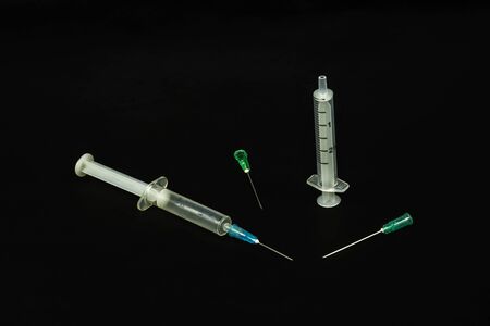 Medical syringe and needles on a black backgroundの写真素材