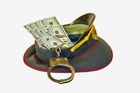 Uniform caps in dollars and in handcuffsの写真素材
