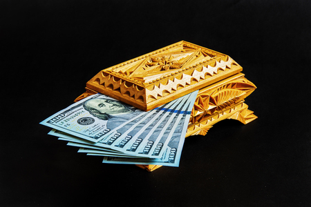Wooden casket handmade with US 100 dollar billsの写真素材