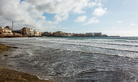 On the shore of the ocean on the island Atlaniticheskogo tenerefe is the town of El Medanoの写真素材