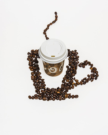 From coffee beans painted silhouette of a cup of hot drink on a white background and a paper cup of coffeeの写真素材